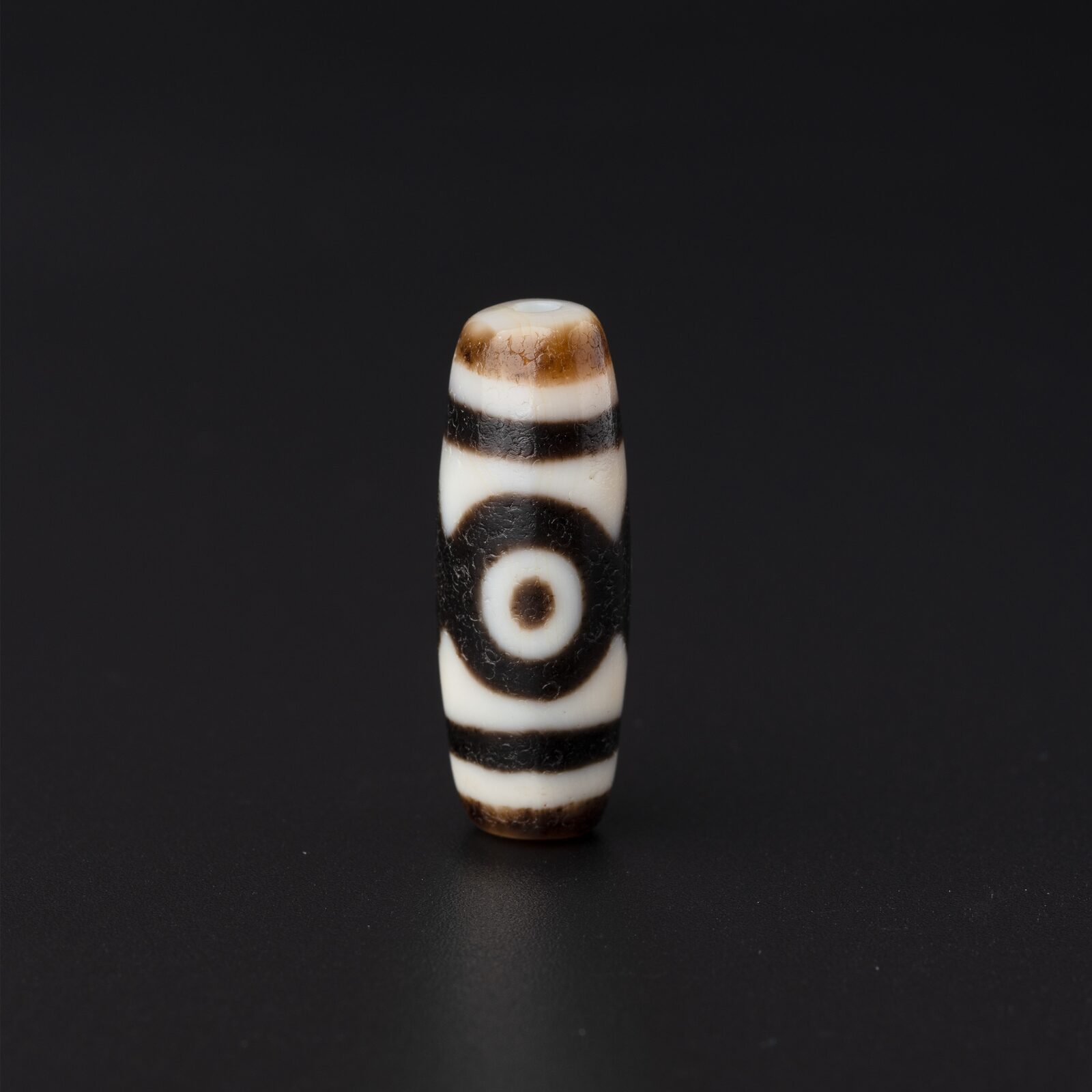 Brown-and-White Bead with a Single Eye