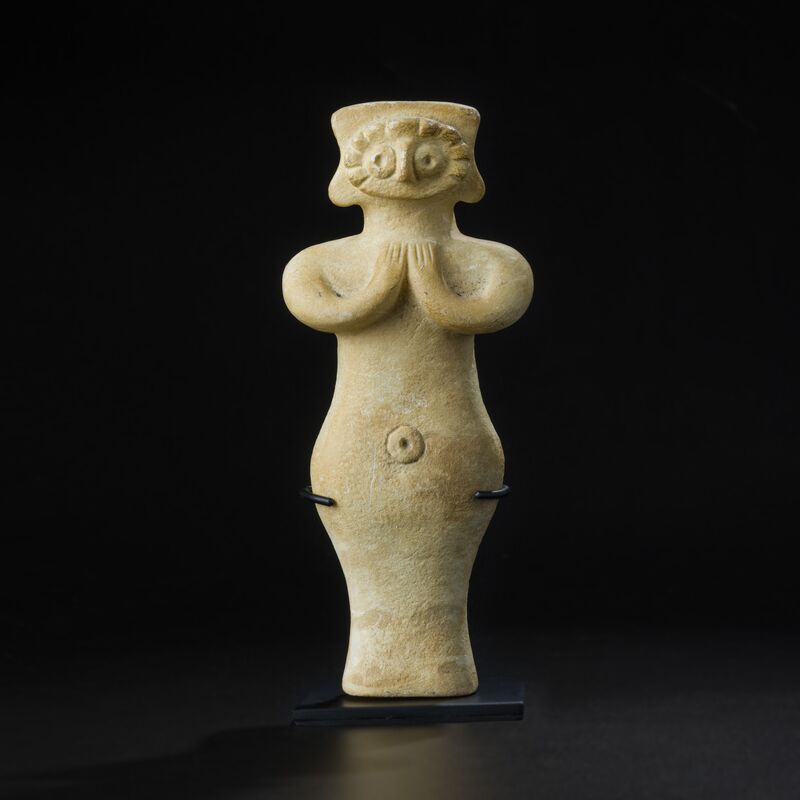 Figure with Ringed Eyes and Clasped Hands