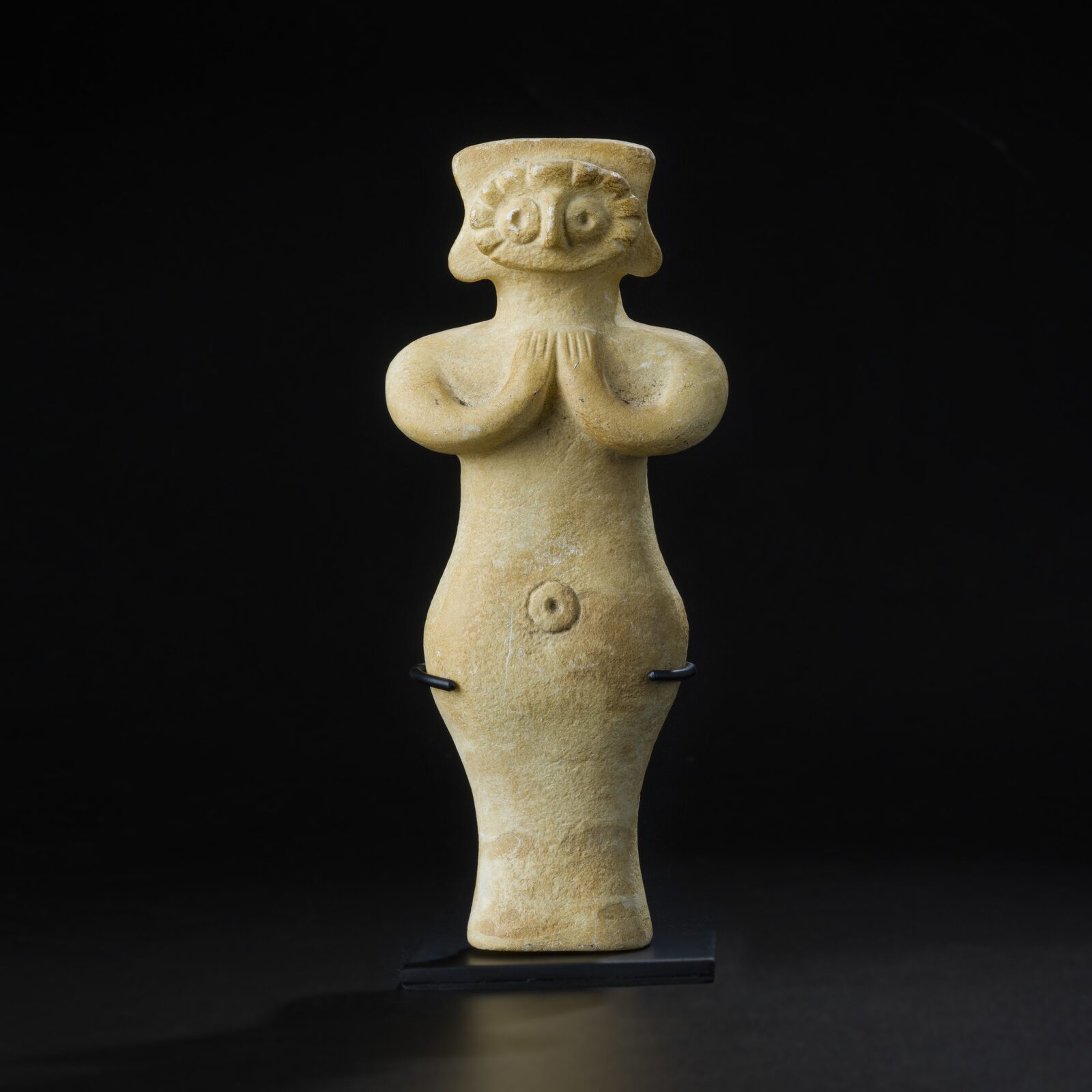 Figure with Ringed Eyes and Clasped Hands