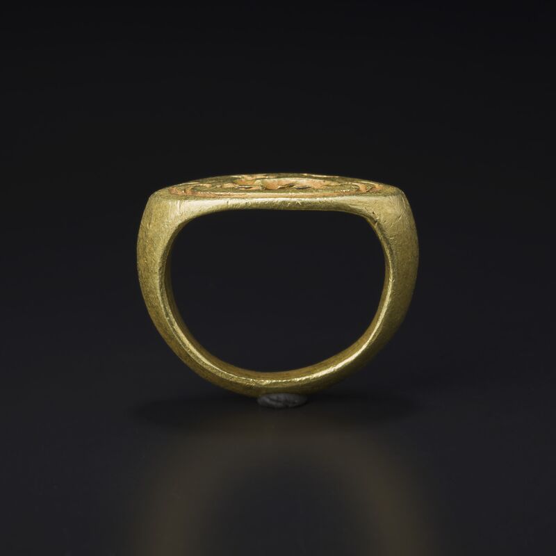 Gold Stirrup Ring with an Engraved Bezel
