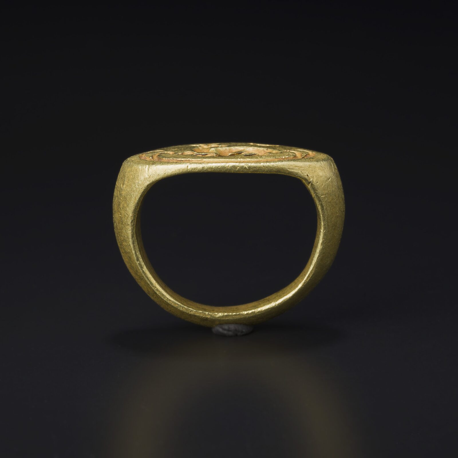 Gold Stirrup Ring with an Engraved Bezel