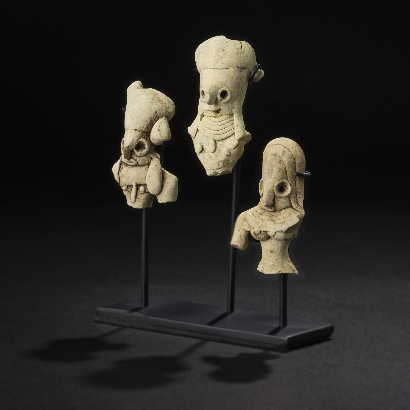Three Figure Heads on a Single Stand